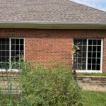 Completed replacement windows on a brick home exterior
